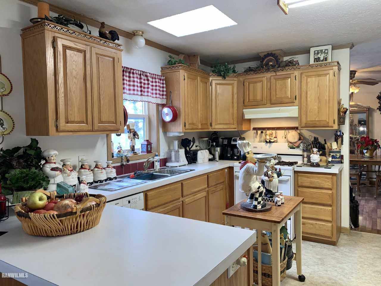 6639 Riverview Road Thomson, IL 61285 - Photo 8 of 20 a kitchen with stainless steel appliances a sink a stove and a refrigerator