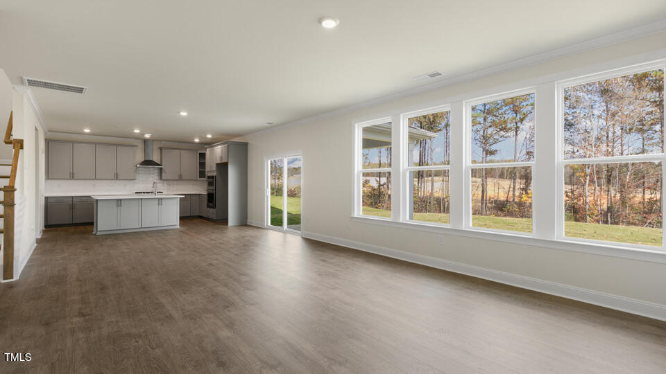 166 Red Jasper Way Clayton, NC 27520 - Photo 12 of 41 a view of an empty room with a window and kitchen view