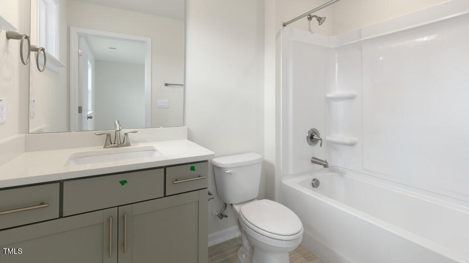 166 Red Jasper Way Clayton, NC 27520 - Photo 17 of 41 a bathroom with a sink toilet vanity and shower