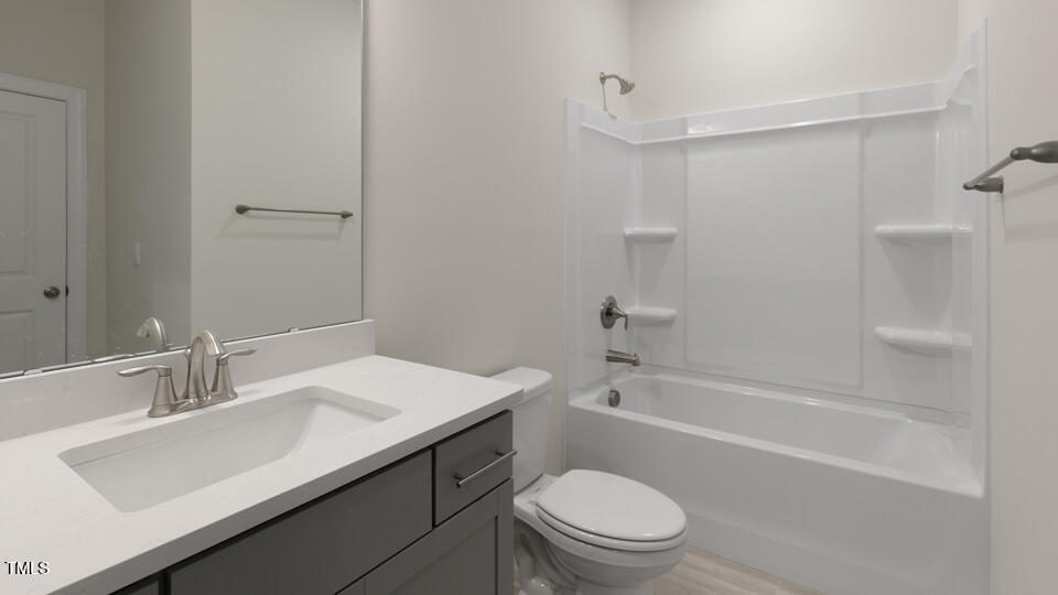 166 Red Jasper Way Clayton, NC 27520 - Photo 18 of 41 a bathroom with a sink a toilet and shower