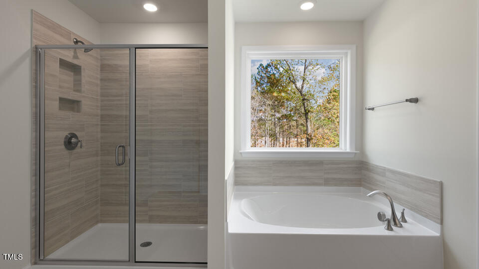 166 Red Jasper Way Clayton, NC 27520 - Photo 23 of 41 a bathroom with a bathtub and shower