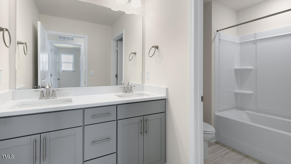 166 Red Jasper Way Clayton, NC 27520 - Photo 30 of 41 a bathroom with a double vanity sink mirror double and bathtub