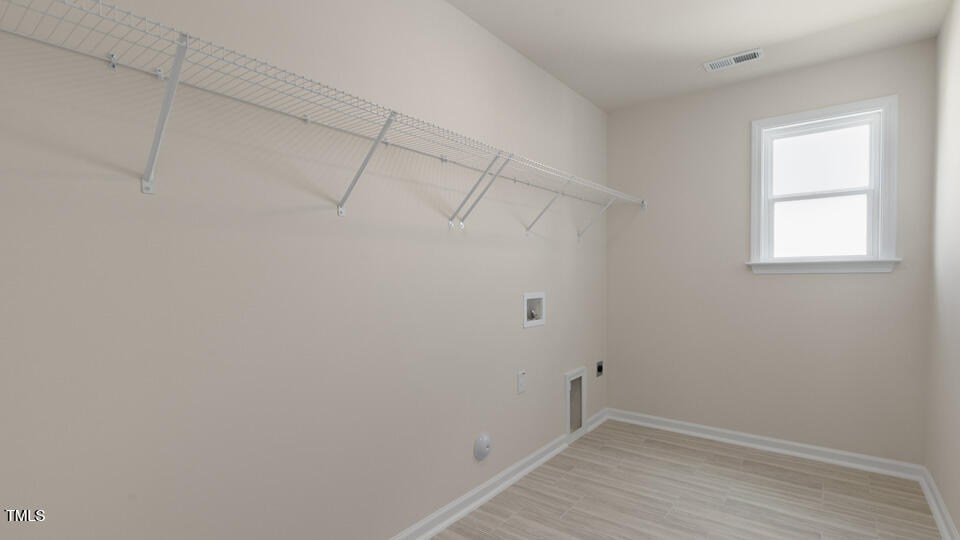 166 Red Jasper Way Clayton, NC 27520 - Photo 31 of 41 a view of a room with racks on the wall