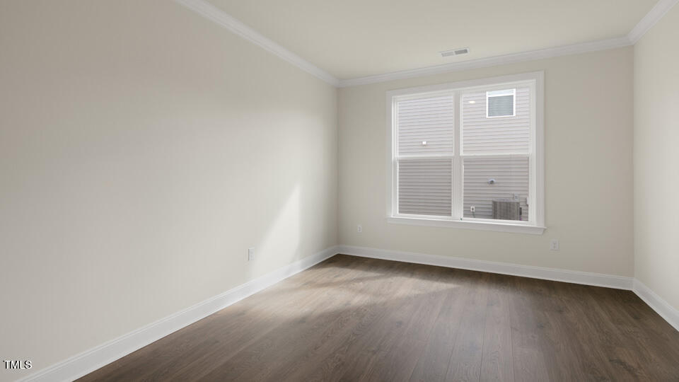 166 Red Jasper Way Clayton, NC 27520 - Photo 5 of 41 an empty room with wooden floor and windows