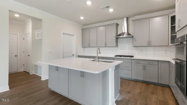 a kitchen with stainless steel appliances a sink stove and refrigerator