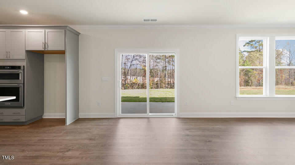 166 Red Jasper Way Clayton, NC 27520 - Photo 10 of 41 an empty room with wooden floor and windows