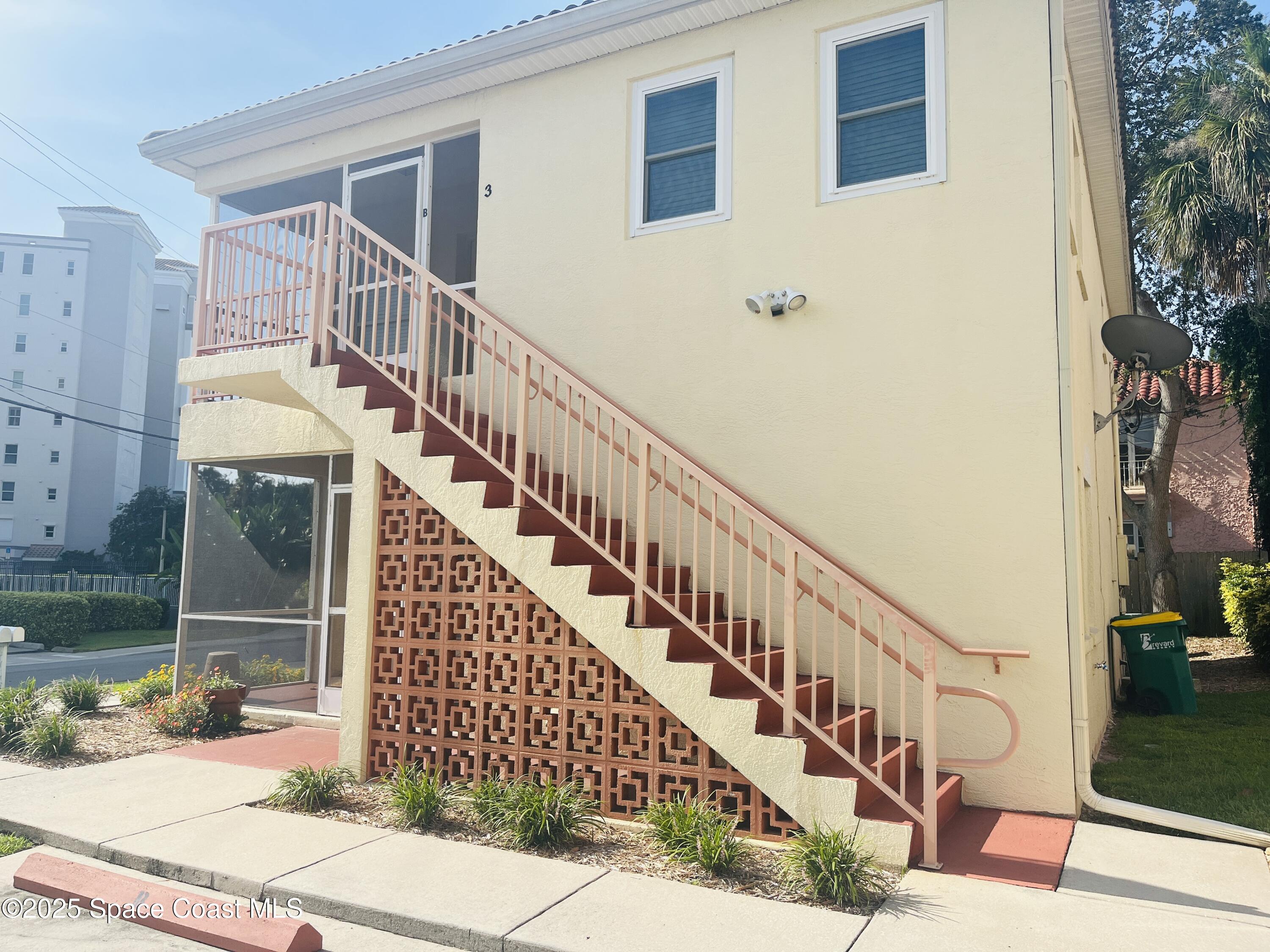 3 Florida Avenue, Unit B Cocoa, FL 32922 - Photo 2 of 10 a view of staircase with wooden floor and a potted plant