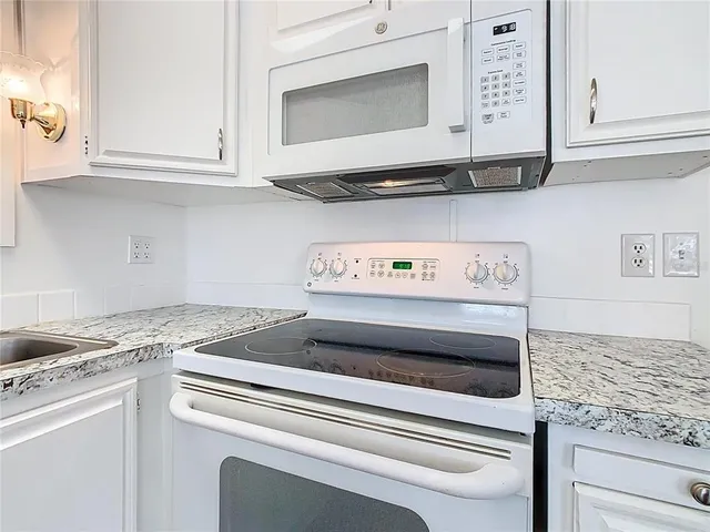 a stove top oven sitting inside of a kitchen