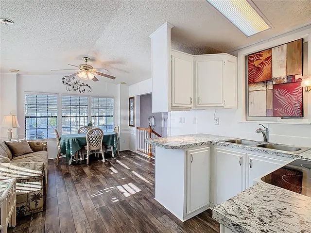 a kitchen with a table chairs stove and cabinets