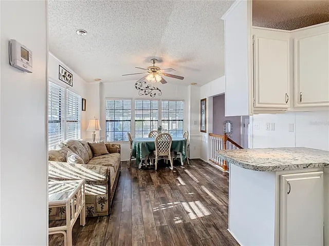 a living room with furniture granite countertop wooden floor and a fireplace