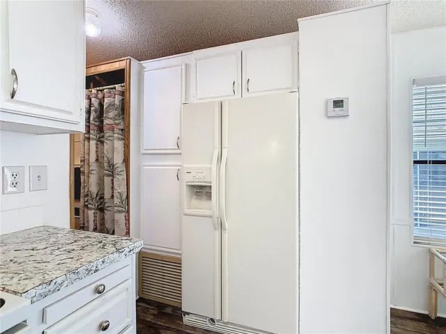 a white refrigerator freezer sitting inside of a kitchen