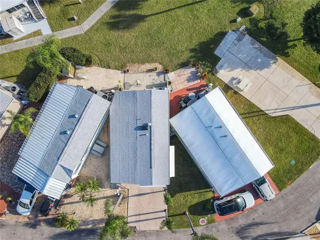 an aerial view of multiple houses with yard
