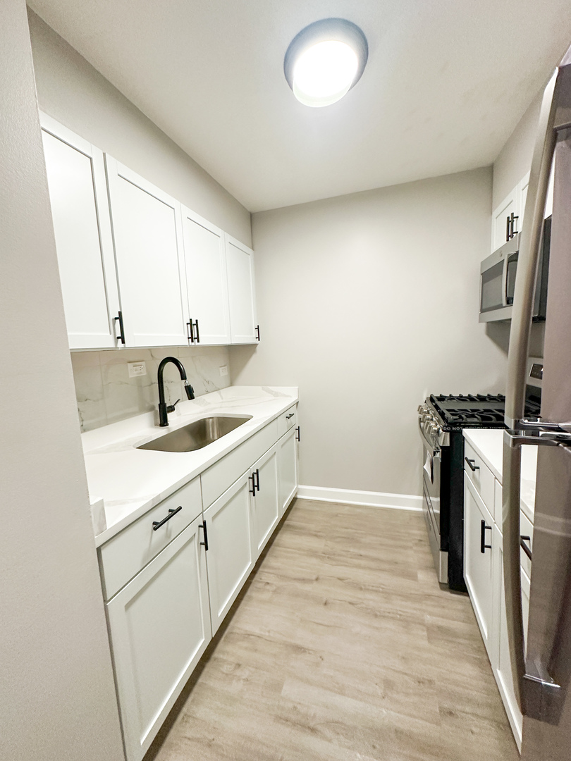 4300 North Keystone Avenue, Unit 3B Chicago, IL 60641 - Photo 5 of 10 a view of a kitchen with sink dryer and washer
