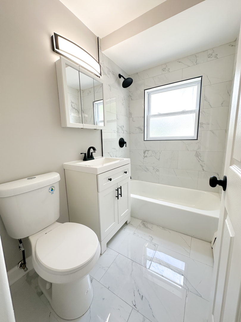 4300 North Keystone Avenue, Unit 3B Chicago, IL 60641 - Photo 8 of 10 a bathroom with a sink toilet vanity and bathtub