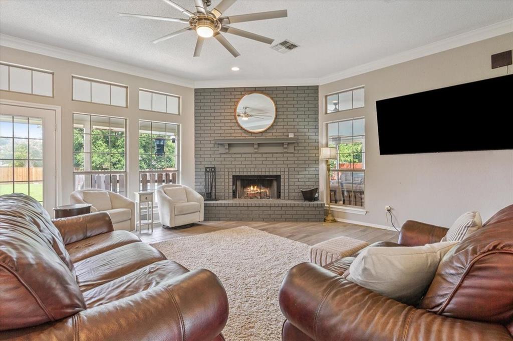 a living room with furniture a fireplace and a flat screen tv