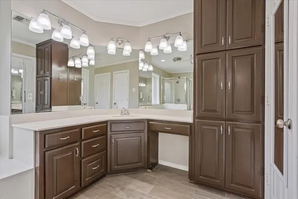 a spacious bathroom with a sink vanity and a mirror
