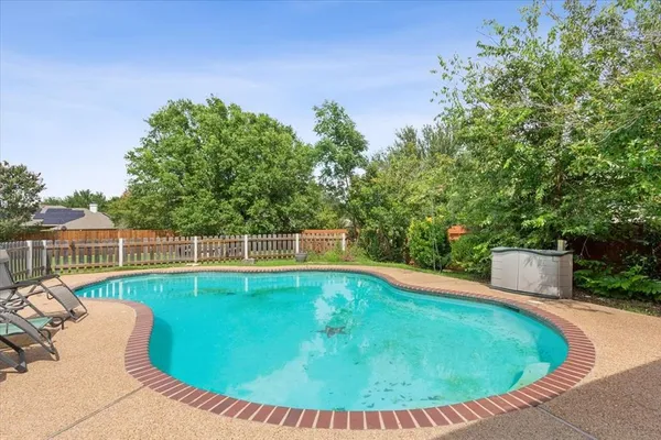 a view of a swimming pool with a patio