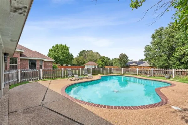 a view of a swimming pool with a patio