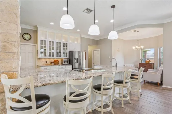 a kitchen with a dining table and chairs
