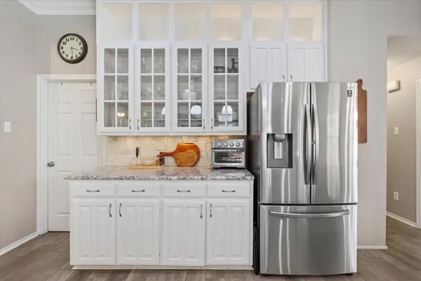 a kitchen with stainless steel appliances granite countertop a refrigerator and a stove top oven