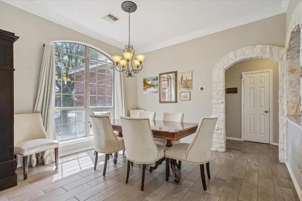a view of a dining room with furniture wooden floor and chandelier
