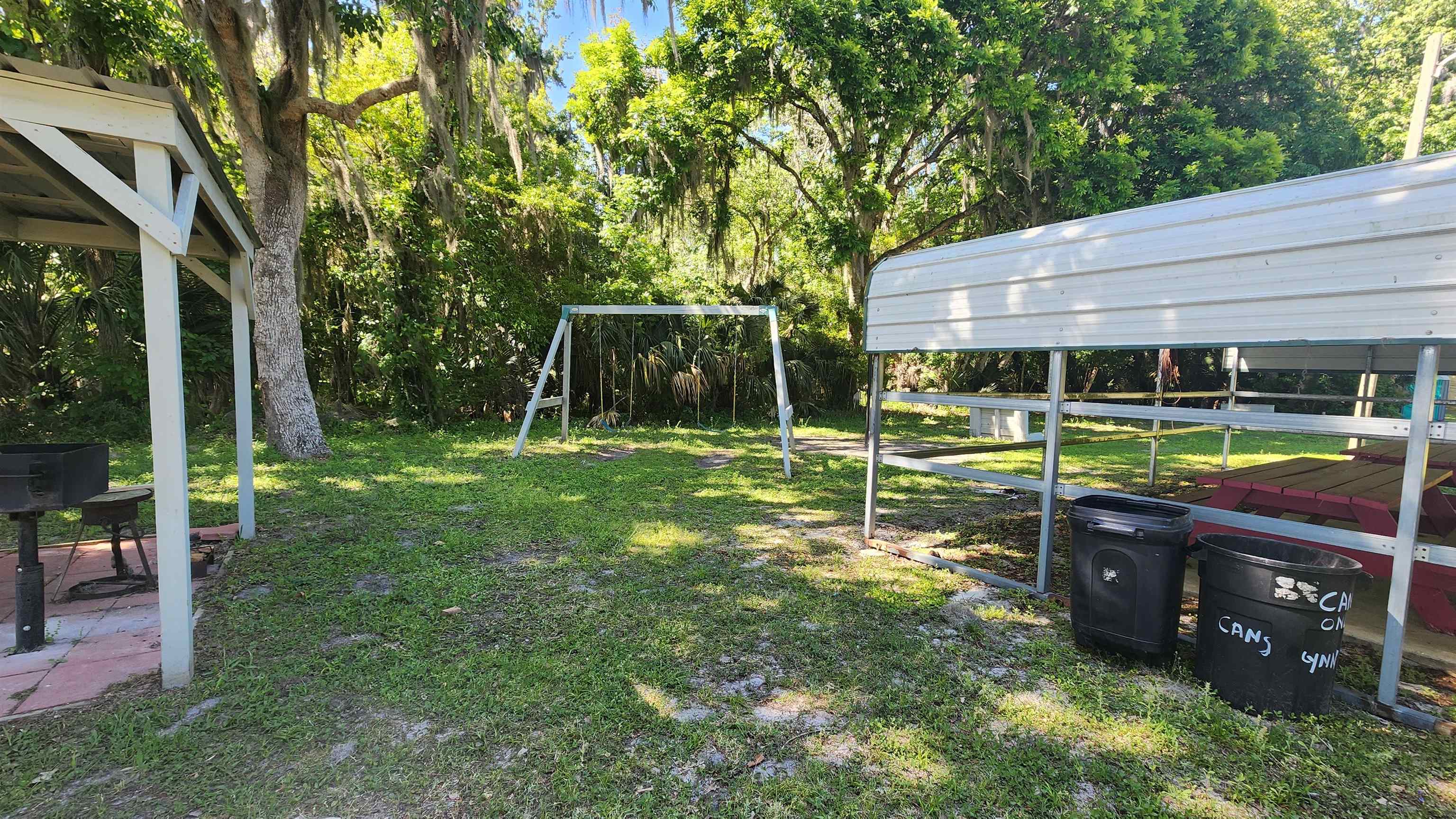 131 Georgetown Denver Road Georgetown, FL 32139 - Photo 9 of 11 a backyard of a house with barbeque oven