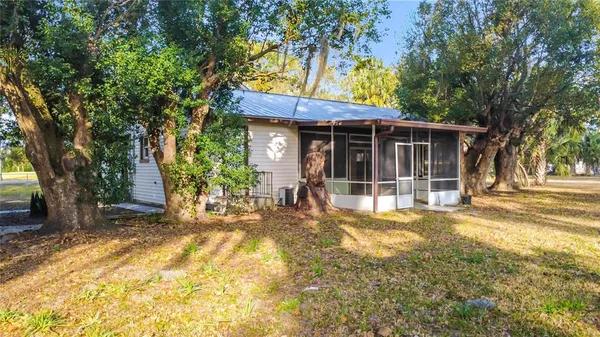 a view of backyard of house with green space