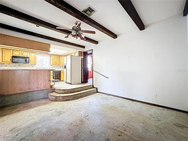 a view of hallway with a large window and wooden floor