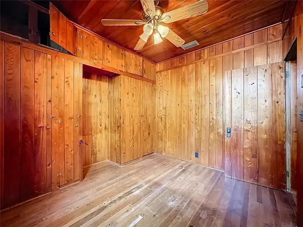 a bathroom with a glass shower door and a mirror