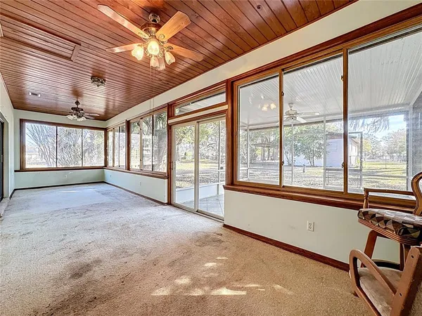 a view of a house with a backyard and a tree