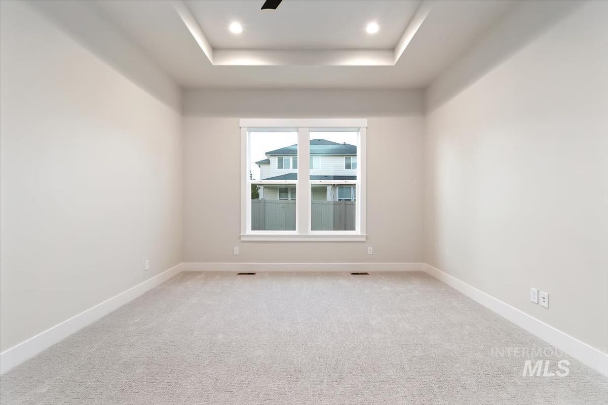 2147 East Blakehurst Avenue Kuna, ID 83634 - Photo 21 of 43 Spare room featuring carpet floors, a raised ceiling, recessed lighting, and ceiling fan