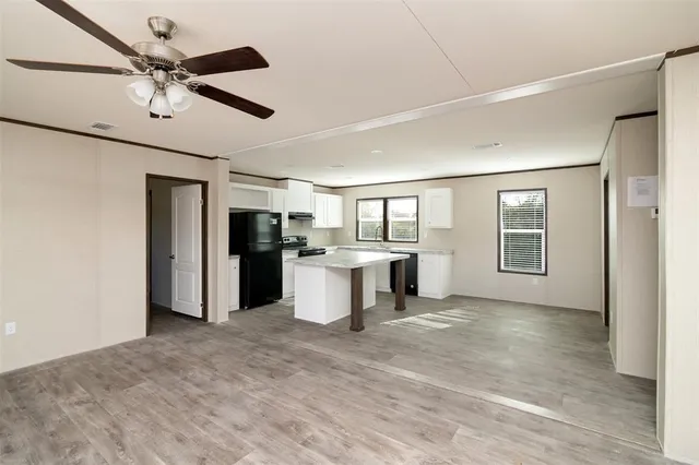 a view of a kitchen with a sink and a refrigerator