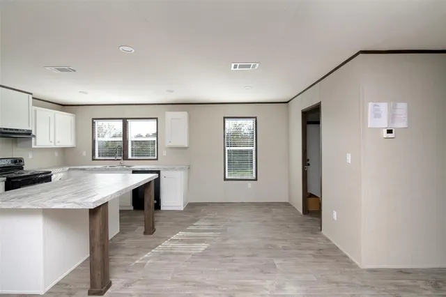 a view of a kitchen with a sink dishwasher and a refrigerator