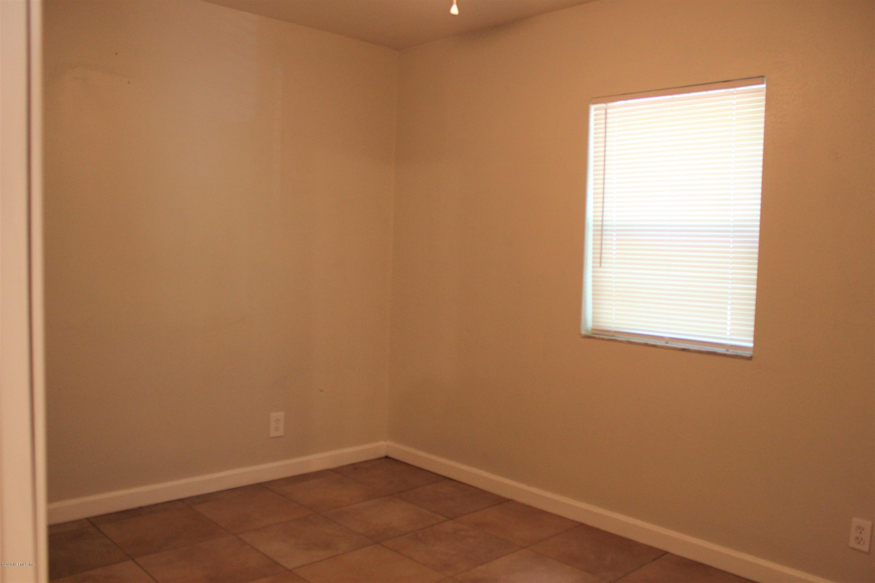 6317 Delacy Road Jacksonville, FL 32244 - Photo 3 of 12 an empty room with a window