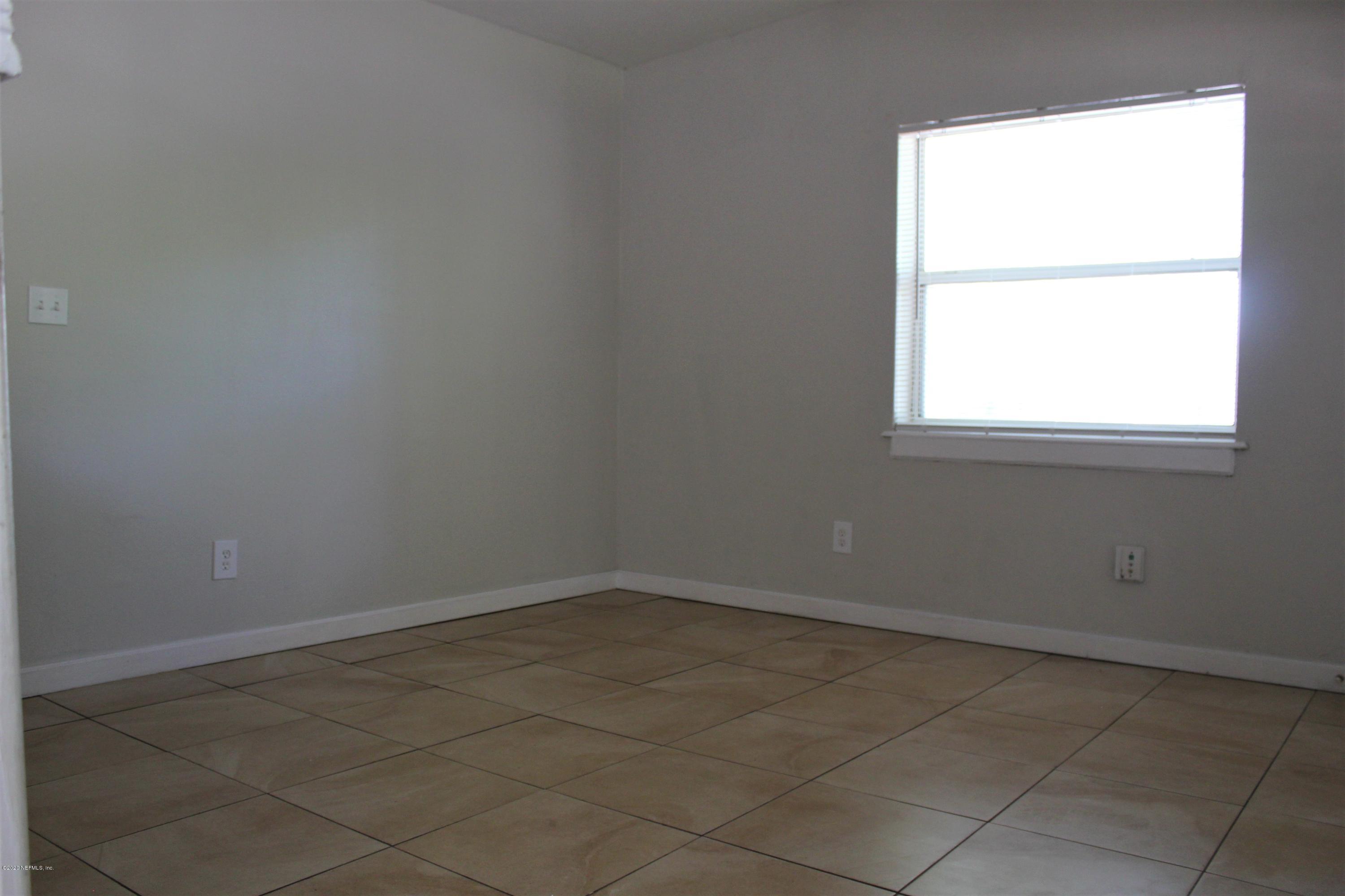 6317 Delacy Road Jacksonville, FL 32244 - Photo 5 of 12 an empty room with a window