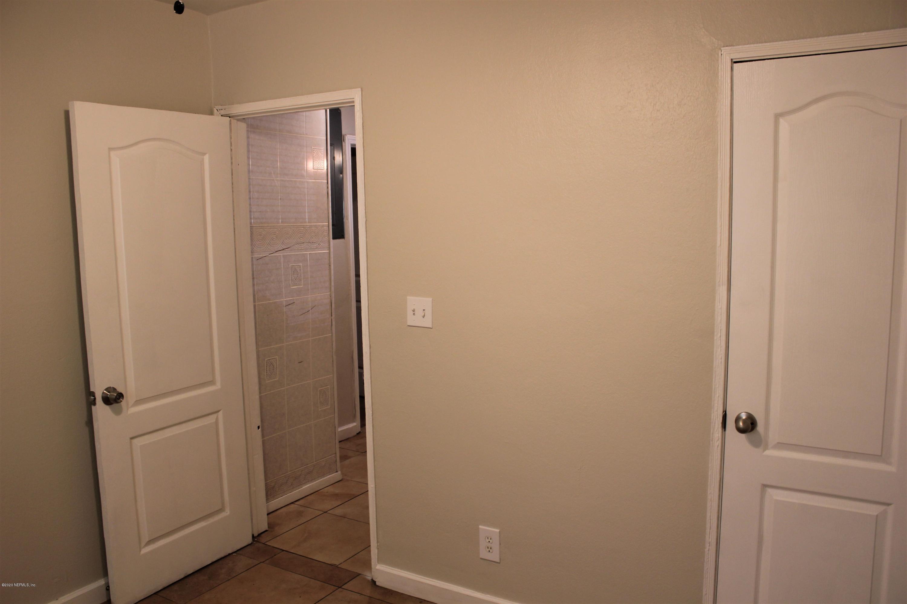 6317 Delacy Road Jacksonville, FL 32244 - Photo 6 of 12 a bathroom with a shower and a glass door