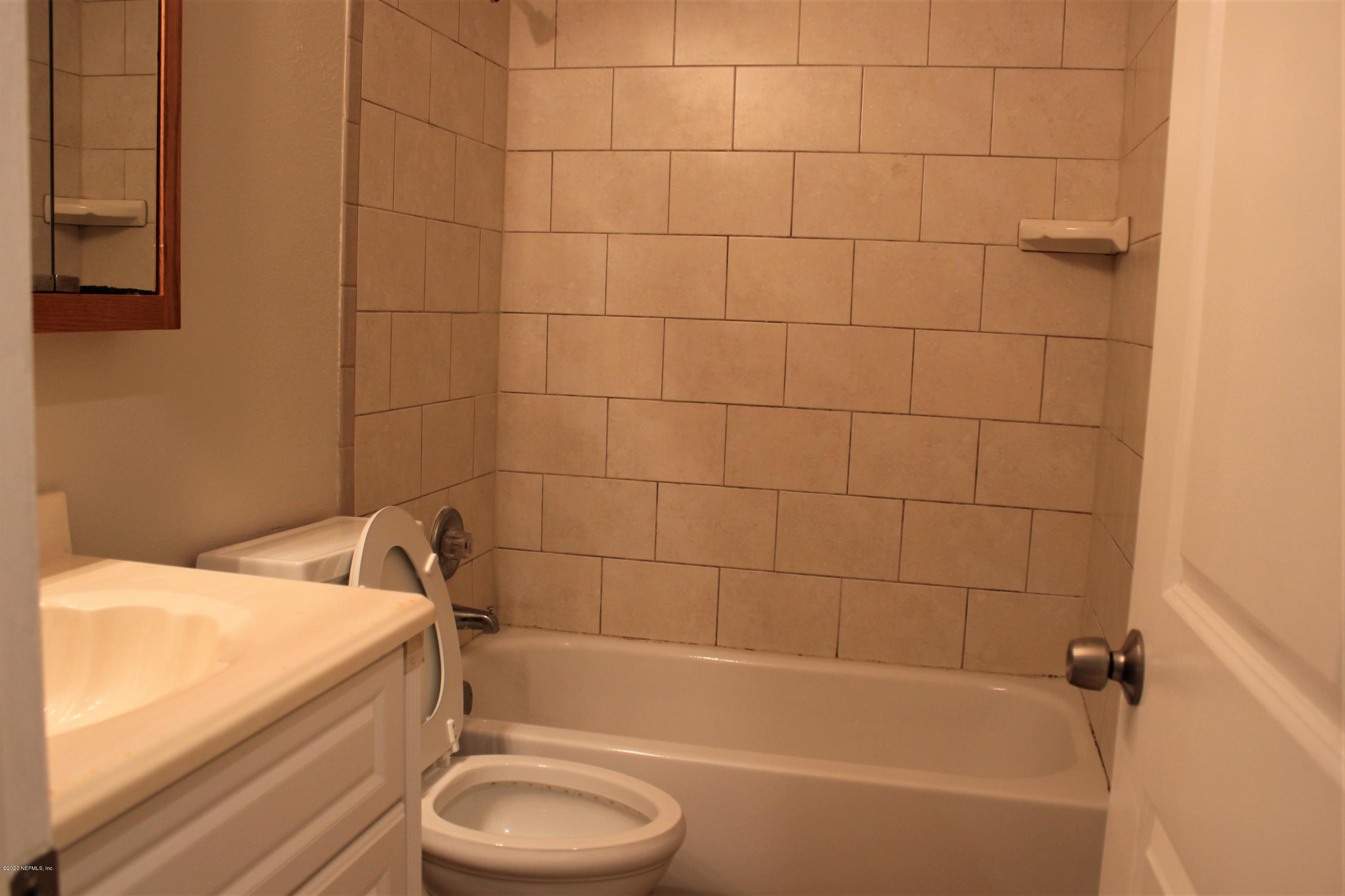 6317 Delacy Road Jacksonville, FL 32244 - Photo 9 of 12 a bathroom with a sink and bathtub