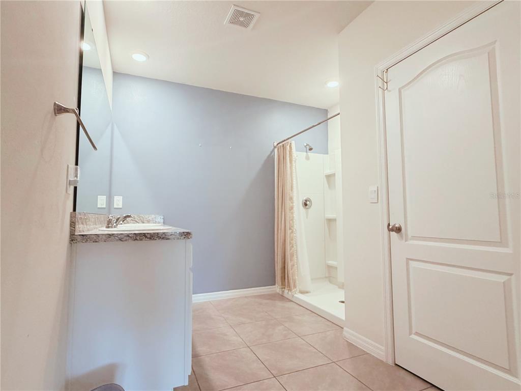 910 Sun Burst Road Winter Haven, FL 33880 - Photo 7 of 14 a view of a kitchen with a sink and refrigerator
