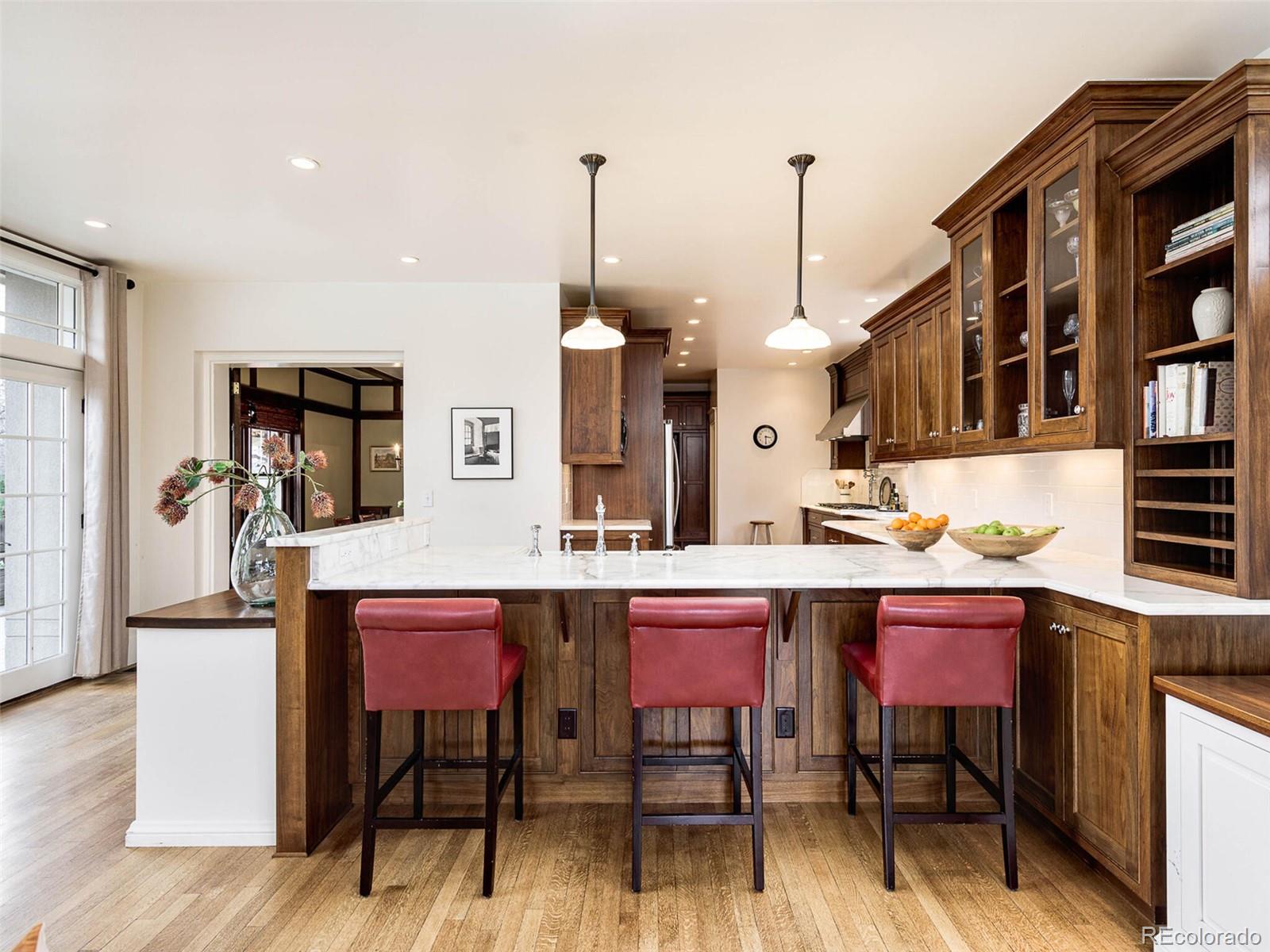 720 Franklin Street Denver, CO 80218 - Photo 13 of 38 a view of dining room and livingroom with furniture wooden floor a rug a painting and a chandelier