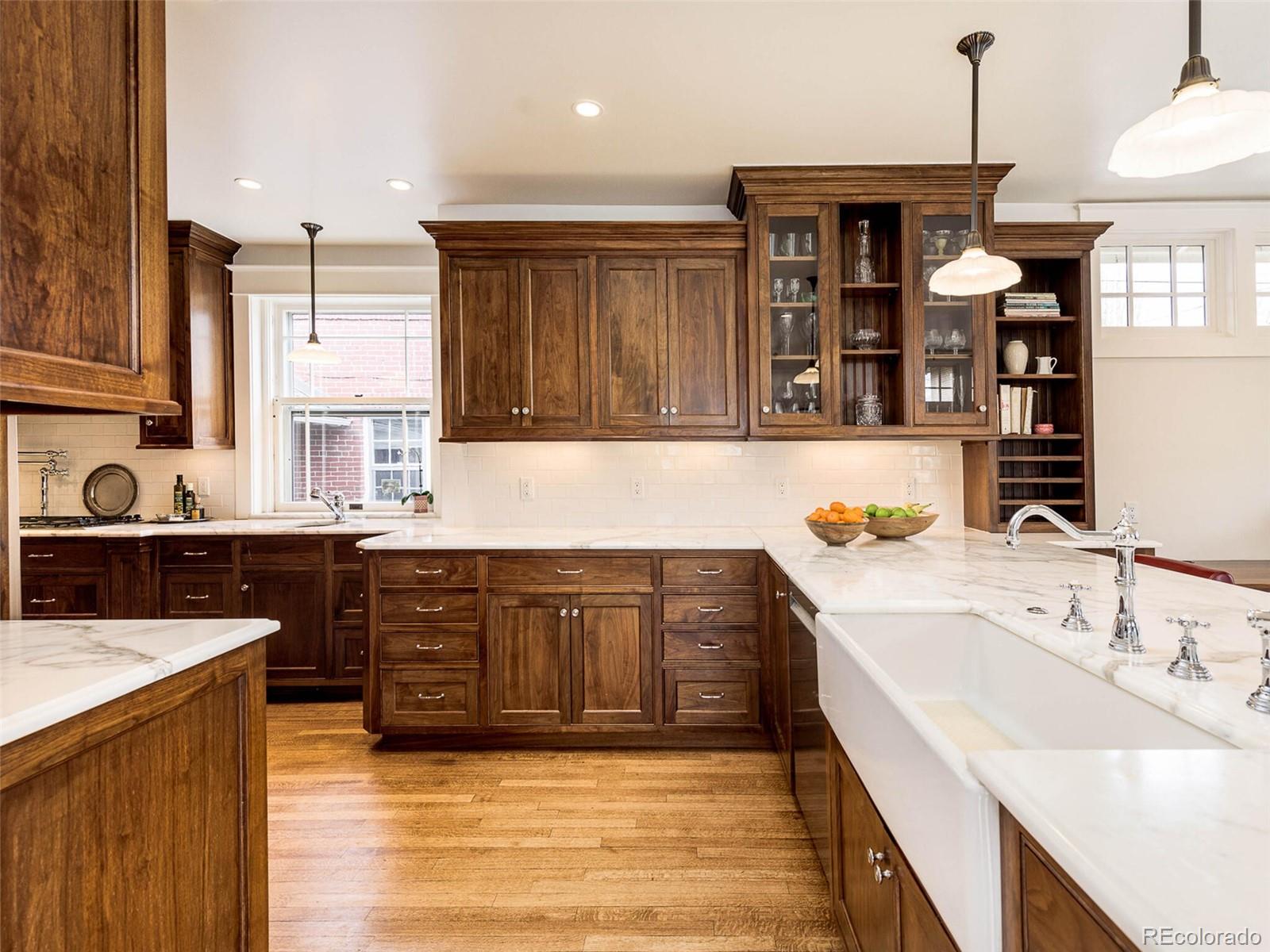 720 Franklin Street Denver, CO 80218 - Photo 14 of 38 a kitchen with a sink stove and cabinets