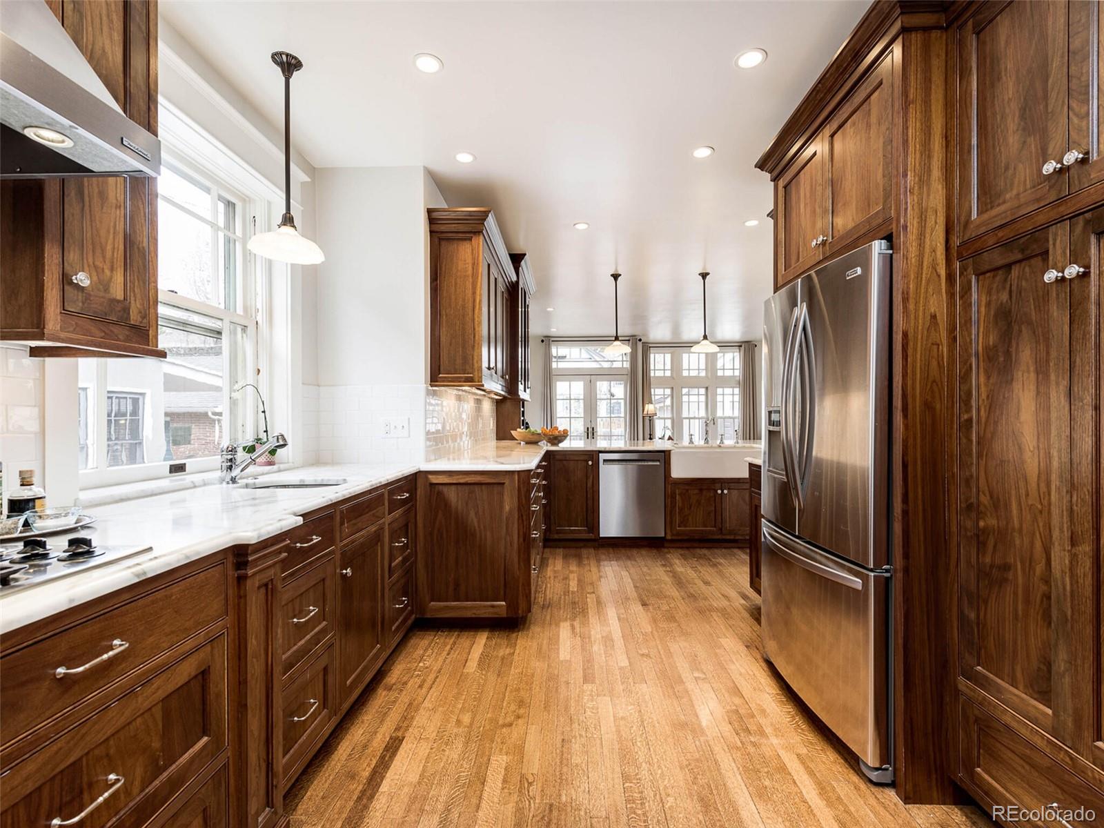 720 Franklin Street Denver, CO 80218 - Photo 15 of 38 a kitchen with stainless steel appliances sink a refrigerator and cabinets