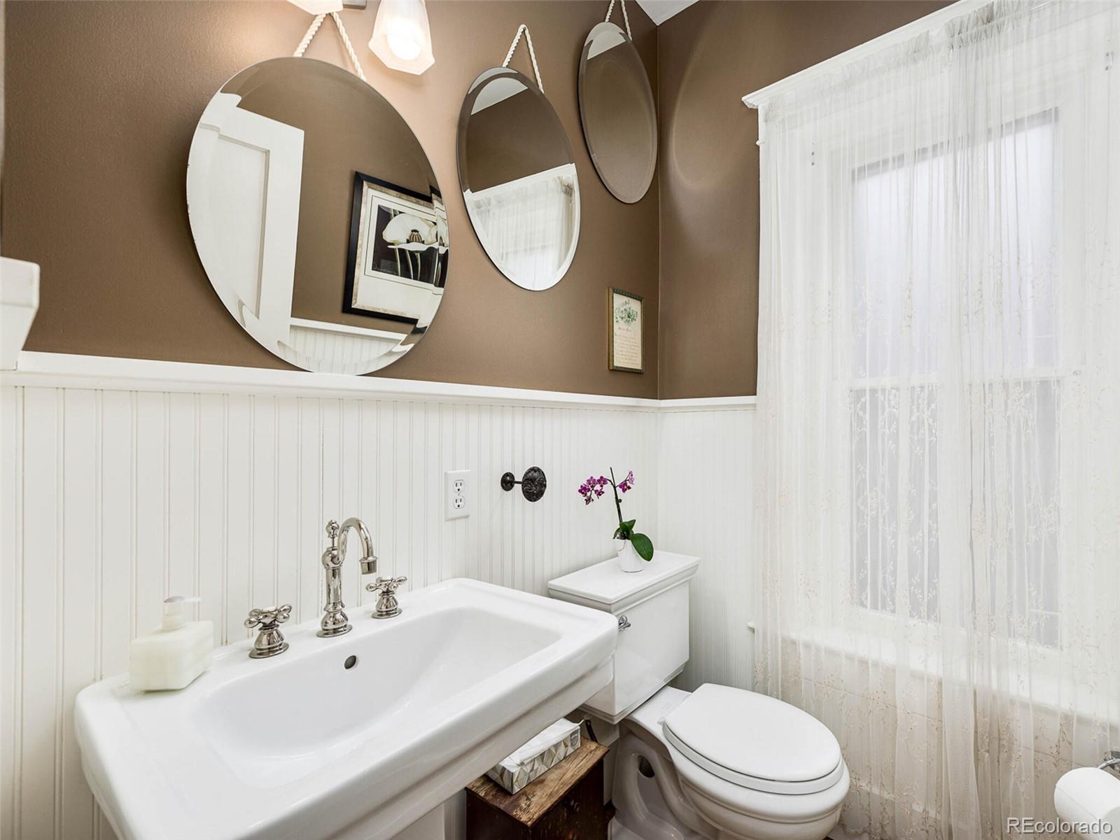 720 Franklin Street Denver, CO 80218 - Photo 16 of 38 a bathroom with a toilet a sink and mirror