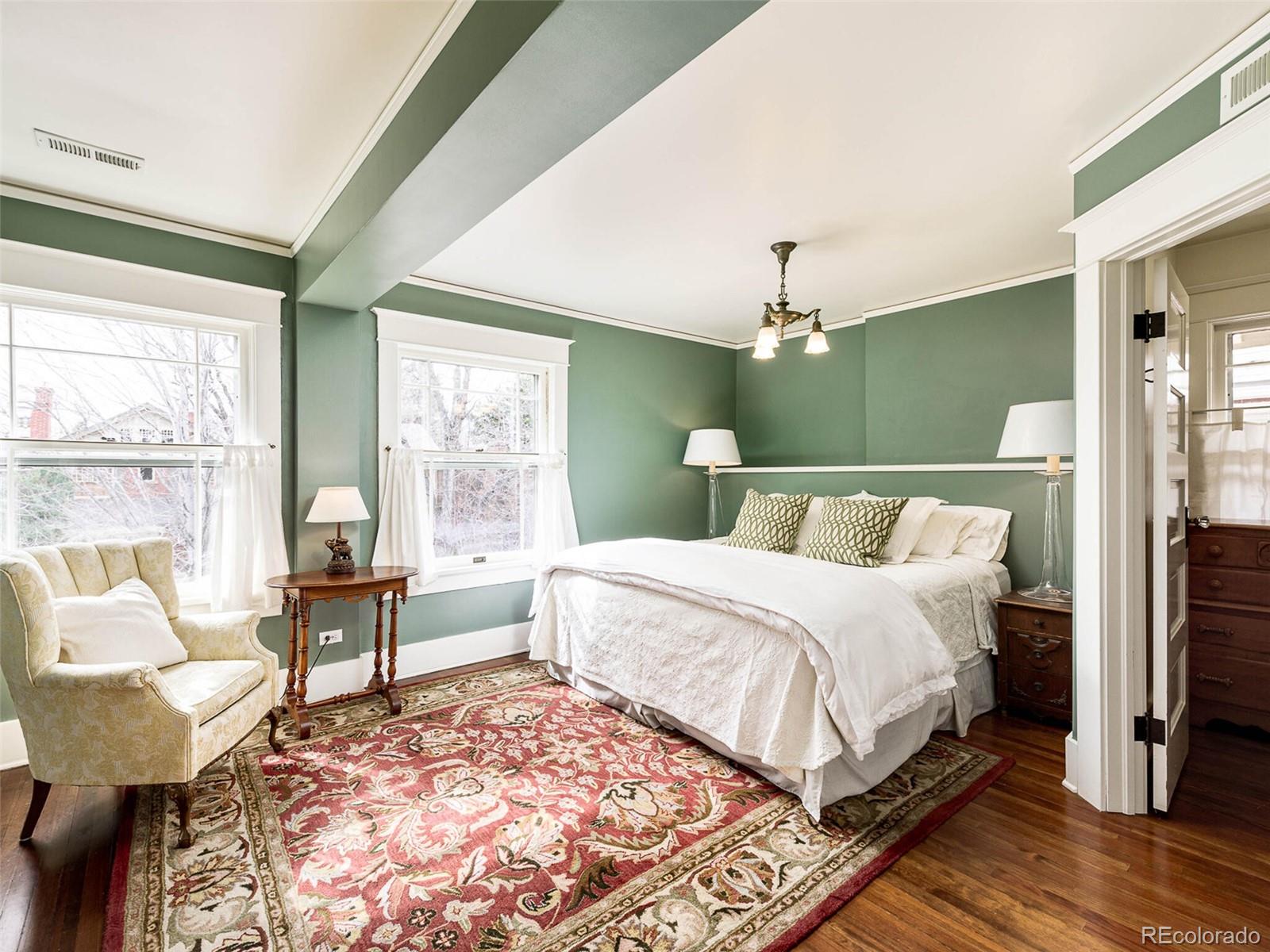720 Franklin Street Denver, CO 80218 - Photo 17 of 38 a bedroom with a large bed and a chandelier
