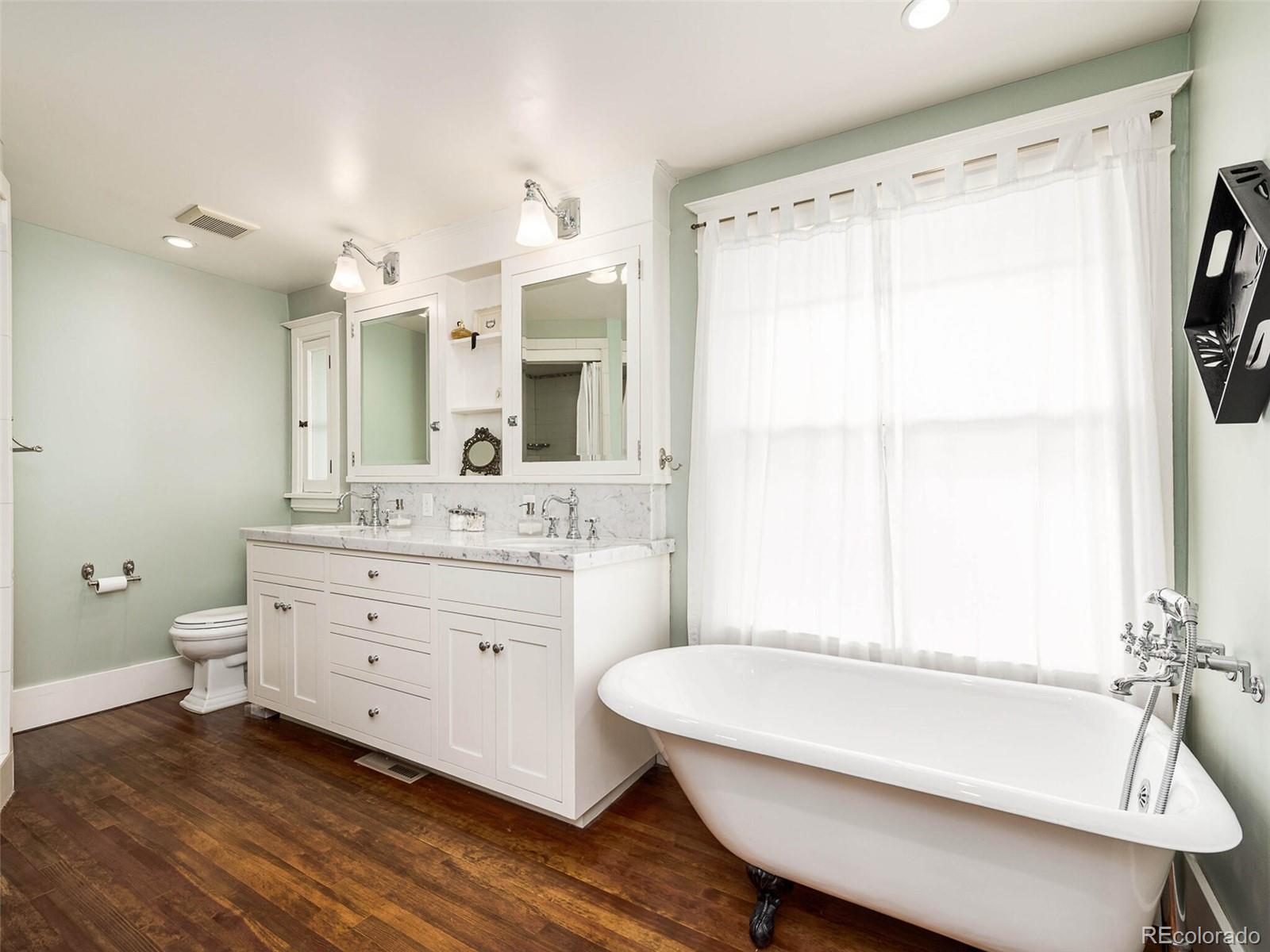 720 Franklin Street Denver, CO 80218 - Photo 18 of 38 a bathroom with a double vanity sink mirror bathtub and toilet