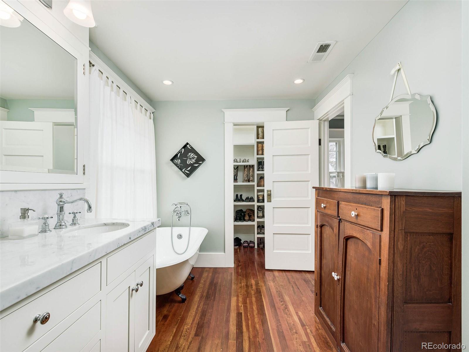 720 Franklin Street Denver, CO 80218 - Photo 19 of 38 a spacious bathroom with a double vanity sink a mirror and a shower