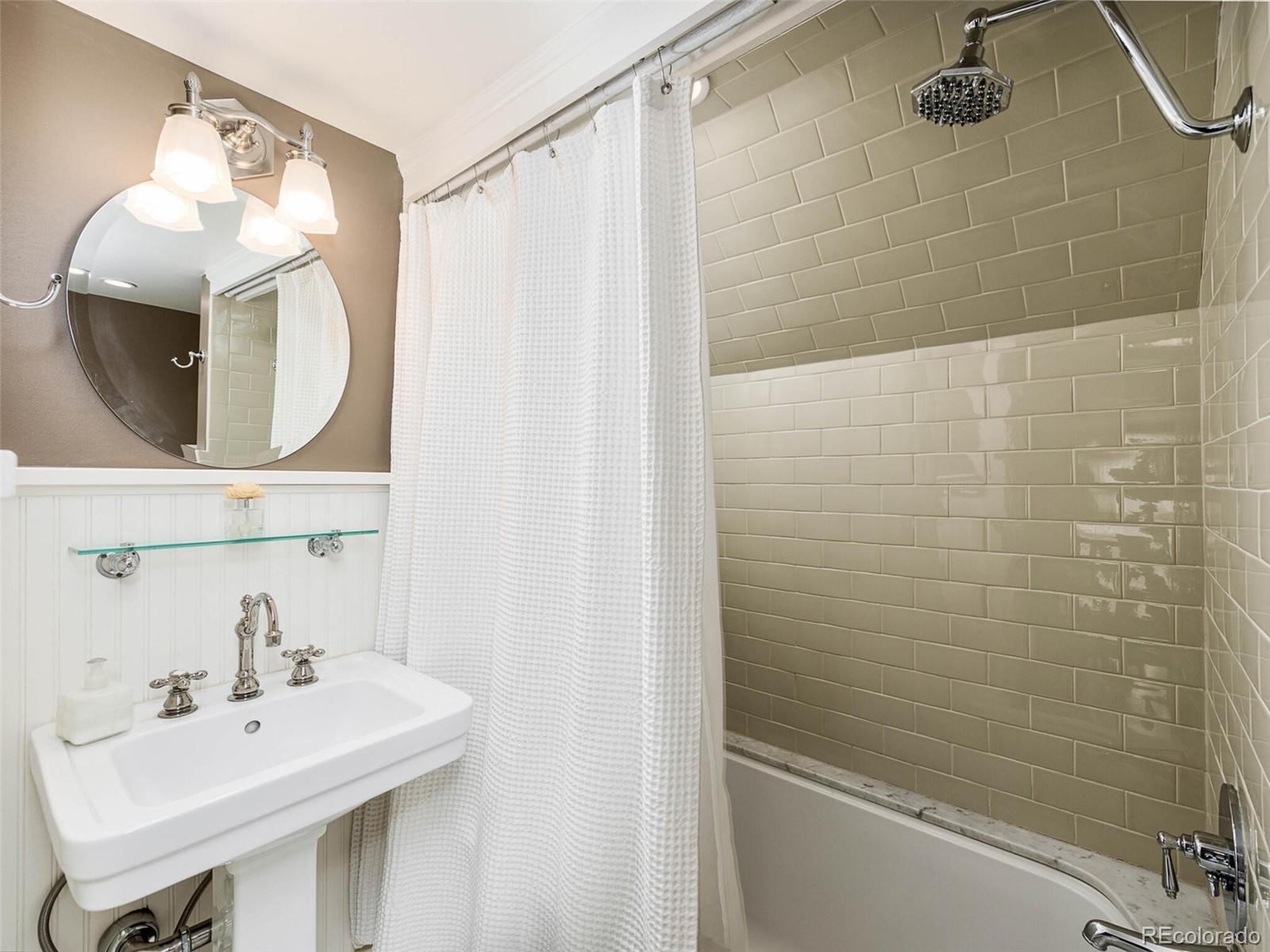 720 Franklin Street Denver, CO 80218 - Photo 27 of 38 a bathroom with a sink a toilet and a mirror