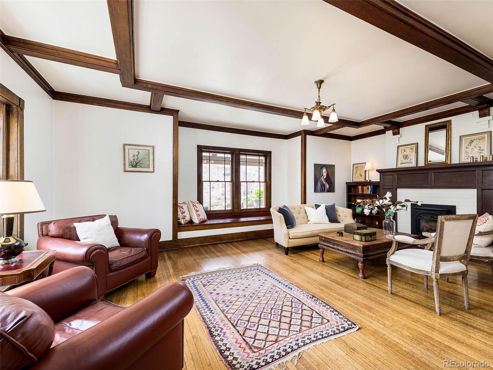 720 Franklin Street Denver, CO 80218 - Photo 4 of 38 a living room with furniture a rug and a chandelier
