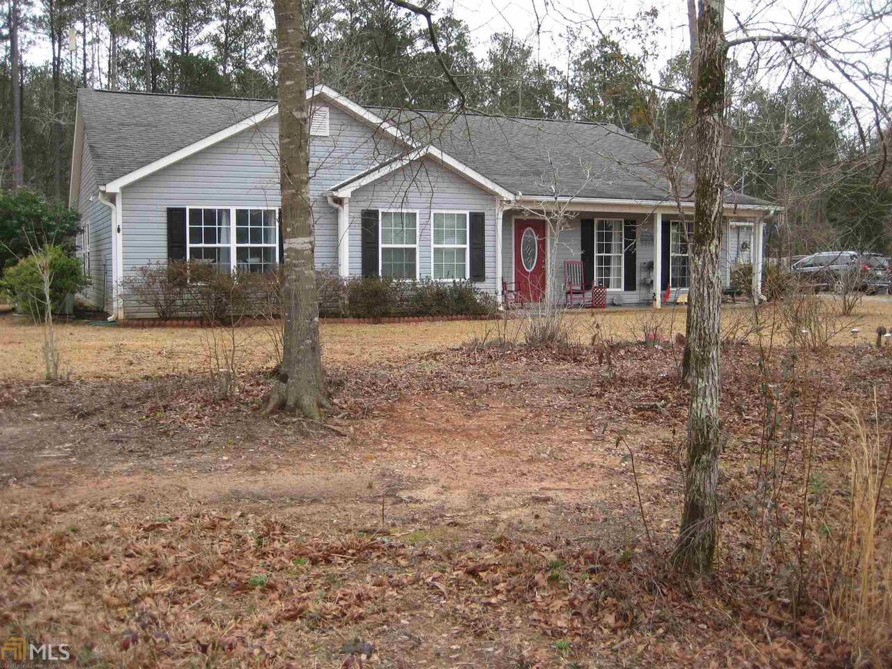 138 McMullen Road Forsyth, GA 31029 - Photo 1 of 1 a view of a yard in front of a house with large windows