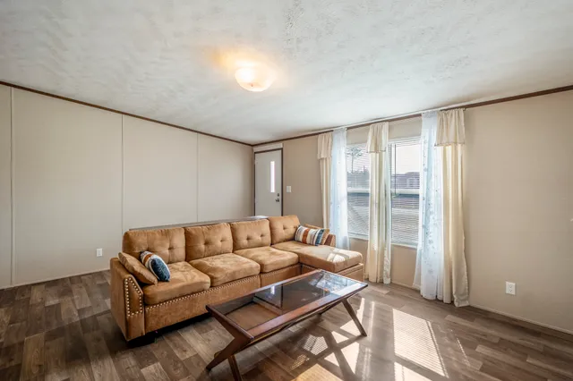 a living room with furniture and a floor to ceiling window
