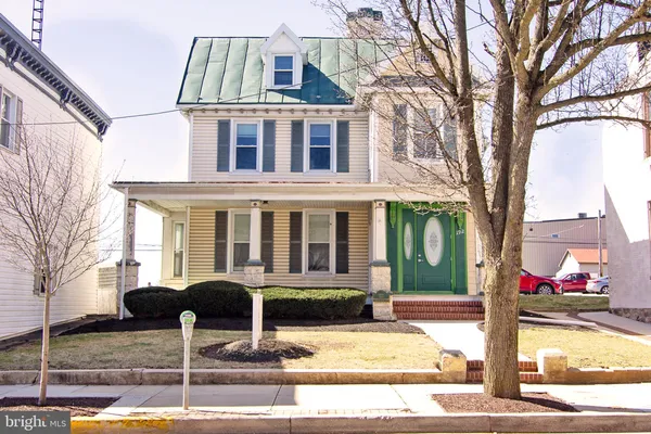 a front view of a house with street view